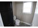 Toilet room featuring a toilet, window, tile flooring and a black storage cabinet at 1365 Willis Lake Dr, Kennesaw, GA 30152