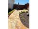 Flagstone patio with a table and chairs, lush landscaping, and privacy fence at 1580 Reids Ferry Way, Marietta, GA 30062