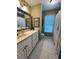 Bathroom with white vanity, large mirror, and tile flooring; window provides natural light at 1580 Reids Ferry Way, Marietta, GA 30062