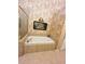 Close up of the bathroom soaking tub framed with stone tile at 1580 Reids Ferry Way, Marietta, GA 30062
