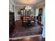 Traditional dining room with chandelier, dark wood table and display cabinet on a decorative rug at 1580 Reids Ferry Way, Marietta, GA 30062