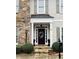 Inviting front door with decorative wreath, stone steps, and manicured landscaping at 1580 Reids Ferry Way, Marietta, GA 30062