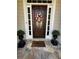 Close-up of a welcoming front door, complete with floral wreath and ornate planters at 1580 Reids Ferry Way, Marietta, GA 30062