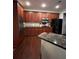 Well-lit kitchen featuring wood cabinets, granite countertops, and modern stainless steel appliances at 1580 Reids Ferry Way, Marietta, GA 30062