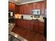 Well-maintained kitchen featuring wooden cabinets, granite countertops, and stainless steel appliances at 1580 Reids Ferry Way, Marietta, GA 30062
