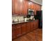Beautiful kitchen featuring wood cabinets, a black fridge and modern stainless steel appliances at 1580 Reids Ferry Way, Marietta, GA 30062