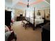 Luxurious primary bedroom with four poster bed and decorative tray ceiling at 1580 Reids Ferry Way, Marietta, GA 30062