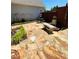 Relaxing patio features flagstone, greenery, a stone bench, and a dining area at 1580 Reids Ferry Way, Marietta, GA 30062