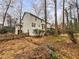 The exterior of the house showcasing a private backyard surrounded by trees at 1935 Wenton Pl, Lawrenceville, GA 30044
