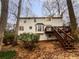 Backyard view featuring a wooden deck, mature trees, and a well-maintained lawn at 1935 Wenton Pl, Lawrenceville, GA 30044