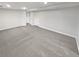Finished basement with neutral carpet, storage shelves, and a nearby door at 1935 Wenton Pl, Lawrenceville, GA 30044