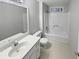 Clean bathroom features a white shower-tub combo and vanity at 1935 Wenton Pl, Lawrenceville, GA 30044