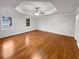 Spacious primary bedroom boasts gleaming hardwood floors and a modern ceiling fan at 1935 Wenton Pl, Lawrenceville, GA 30044