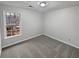 Cozy bedroom with a window for natural light and neutral carpet at 1935 Wenton Pl, Lawrenceville, GA 30044