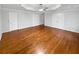 Large primary bedroom with hardwood floors and double door closets at 1935 Wenton Pl, Lawrenceville, GA 30044
