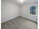 Bedroom with a neutral color scheme, a window letting in natural light, and carpet floors at 1935 Wenton Pl, Lawrenceville, GA 30044