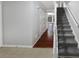Hallway with stairs and access to the dining room, featuring hardwood floors at 1935 Wenton Pl, Lawrenceville, GA 30044