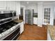 Modern kitchen with stainless appliances, granite counters, and white cabinets at 1935 Wenton Pl, Lawrenceville, GA 30044