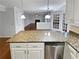 Kitchen island with granite countertops overlooking a living area with a fireplace at 1935 Wenton Pl, Lawrenceville, GA 30044