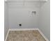 Small laundry room with tile flooring and shelving at 1935 Wenton Pl, Lawrenceville, GA 30044