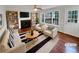 Bright living room featuring a fireplace, built-in bookshelves, and large windows at 1935 Wenton Pl, Lawrenceville, GA 30044