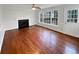 Bright living room featuring a fireplace, large windows, and hardwood floors at 1935 Wenton Pl, Lawrenceville, GA 30044