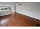 Open-concept living room boasts hardwood floors and seamless access to the adjacent kitchen at 1935 Wenton Pl, Lawrenceville, GA 30044