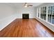 Bright living room features gleaming hardwood floors, a modern fireplace, and large windows at 1935 Wenton Pl, Lawrenceville, GA 30044