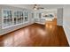 Sunlit living room flows into an eat-in kitchen, featuring hardwood floors and large windows at 1935 Wenton Pl, Lawrenceville, GA 30044