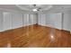 Spacious main bedroom with tray ceiling, ceiling fan, and gleaming hardwood floors at 1935 Wenton Pl, Lawrenceville, GA 30044
