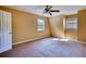 Cozy bedroom featuring neutral carpet, a ceiling fan, and large windows for natural light at 2194 Highway 20 E., Mcdonough, GA 30252