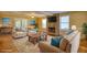 Inviting living room with a stone fireplace, neutral furniture, and bright natural light at 2194 Highway 20 E., Mcdonough, GA 30252