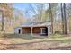 Exterior view of a barn outbuilding with a metal roof and open bay at 2194 Highway 20 E., Mcdonough, GA 30252