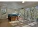 Enclosed sunroom featuring a hot tub, lattice, screens, and views of the surrounding trees at 2194 Highway 20 E., Mcdonough, GA 30252