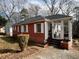 A cozy red brick house with a sunroom addition and well-maintained landscaping at 804 Maynard Ter, Atlanta, GA 30316