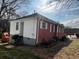 Back view of a house with a brick and white siding exterior and a small deck at 804 Maynard Ter, Atlanta, GA 30316
