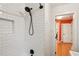 Shower with white subway tiles and a view of the hallway through the doorway at 1322 Elmhurst Circle Se Cir, Atlanta, GA 30316