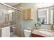 Bathroom featuring glass shower doors, stone vanity, and wood storage cabinet at 1322 Elmhurst Circle Se Cir, Atlanta, GA 30316