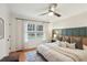 Relaxing bedroom featuring a ceiling fan, hardwood floors, and a serene view from the window at 1322 Elmhurst Circle Se Cir, Atlanta, GA 30316