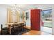 Bright dining area with a chandelier, light walls, and a striking red door, seamlessly blending style and functionality at 1322 Elmhurst Circle Se Cir, Atlanta, GA 30316