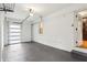 Garage with concrete floor, overhead storage, a multi-pane garage door and an entry door to the house at 1322 Elmhurst Circle Se Cir, Atlanta, GA 30316