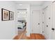 Bright hallway featuring hardwood floors and a glimpse into a bedroom with a stylish bed at 1322 Elmhurst Circle Se Cir, Atlanta, GA 30316