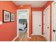 Hallway view showing bedroom entrance with stylish decor and freshly painted orange walls at 1322 Elmhurst Circle Se Cir, Atlanta, GA 30316