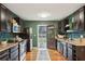 Well-appointed kitchen with dark wood cabinets, green walls, and backyard access, creating a seamless flow to outdoor spaces at 1322 Elmhurst Circle Se Cir, Atlanta, GA 30316