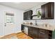 Eat-in kitchen featuring dark wood cabinets, granite countertops, stainless appliances and door to outside at 1322 Elmhurst Circle Se Cir, Atlanta, GA 30316