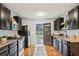 Bright kitchen with dark cabinets, light walls, and an exterior door, seamlessly connecting to the backyard for easy access at 1322 Elmhurst Circle Se Cir, Atlanta, GA 30316