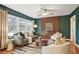 Bright living room featuring hardwood floors, green walls, and large windows for natural light at 1322 Elmhurst Circle Se Cir, Atlanta, GA 30316