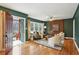 Stylish living room with hardwood floors, green walls, and decorative wooden wall at 1322 Elmhurst Circle Se Cir, Atlanta, GA 30316