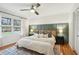 Bright main bedroom with a paneled accent wall, a ceiling fan and two windows overlooking backyard at 1322 Elmhurst Circle Se Cir, Atlanta, GA 30316