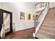 Bright, two-story foyer features hardwood floors, decorative art, and a staircase at 3815 Beaver Swamp Rd, Loganville, GA 30052